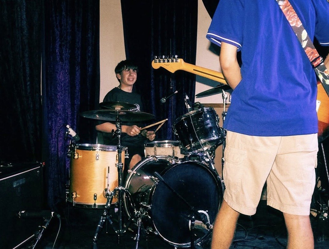 Moses grinning behind the kit