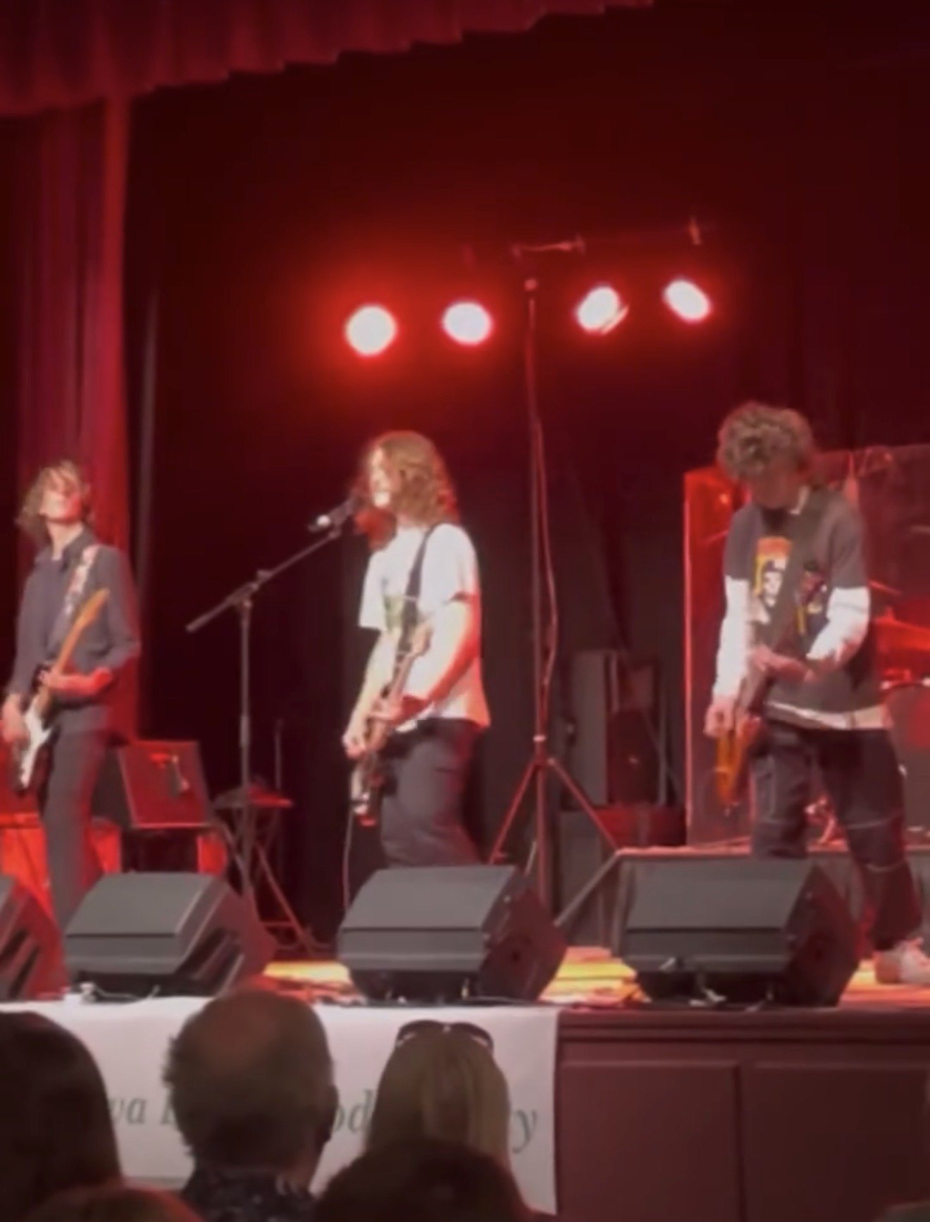 The band under red stage lights