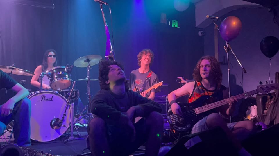 The band hanging out on stage